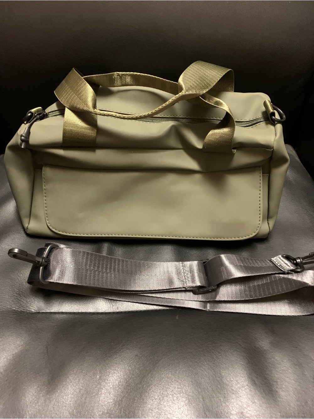 Olive green daily duffle bag. With pocket on front & shoulder strap